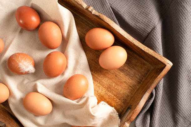 istock Fresh eggs on a linen cloth and wooden tray 1939770228