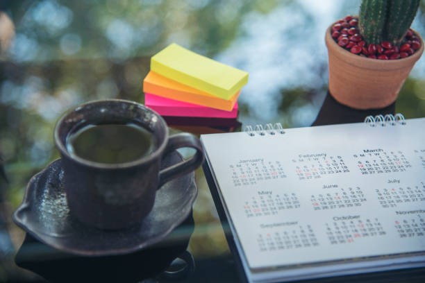 istock 2024 Calendar event planner timetable agenda plan on organize schedule event. Wedding planner agenda organizing timetable by organizer schedule. Calendar desk objects on office table in green park 1939785656