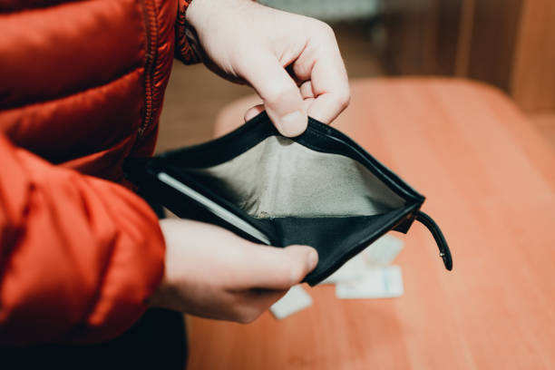 istock Mans hands checking wallet near desk.close up,toned.Blurred background.Soft focus. 1939787341