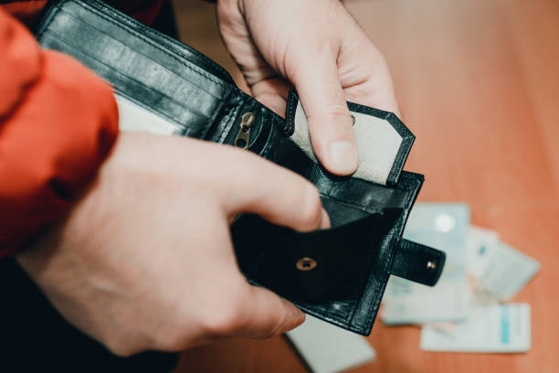 istock Mans hands checking wallet near desk.close up,toned.Blurred background.Soft focus. 1939790659