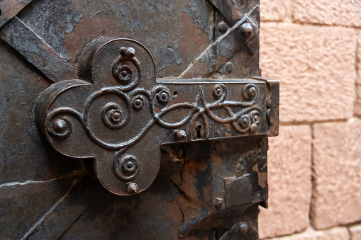 Beautiful, antique, forged door with a round handle. photo taken in Krakow on the main square.