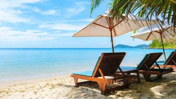 Koh Samet Island Rayong Thailand, beach chairs sunbed with umbrellas at the white tropical beach of Samed Island with a turqouse colored ocean