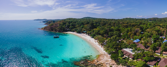Koh Samet Island Thailand, aerial drone view from above at the Samed Island in Thailand with a turqouse colored ocean and a white tropical beach and a blue sky