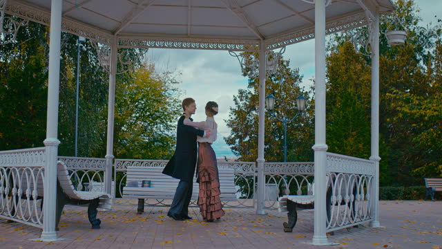 happy loving man and woman dancing waltz in park, history of 19th century, romantic date, 4K, Prores