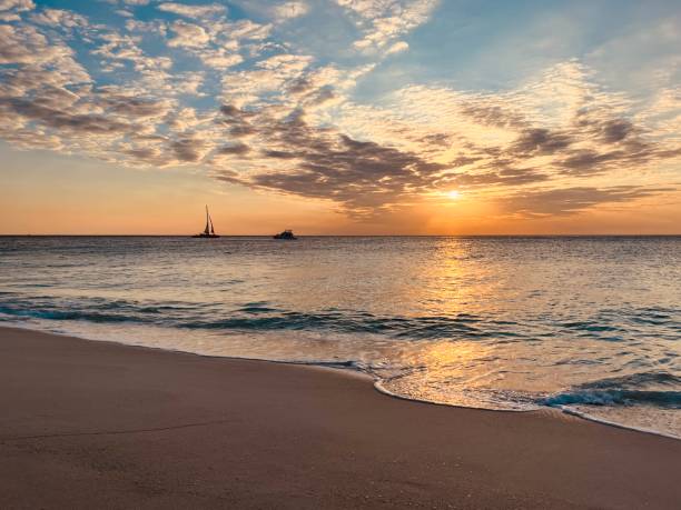 colorful sunset over the sea. - sailing sailboat sunset aruba photos et images de collection