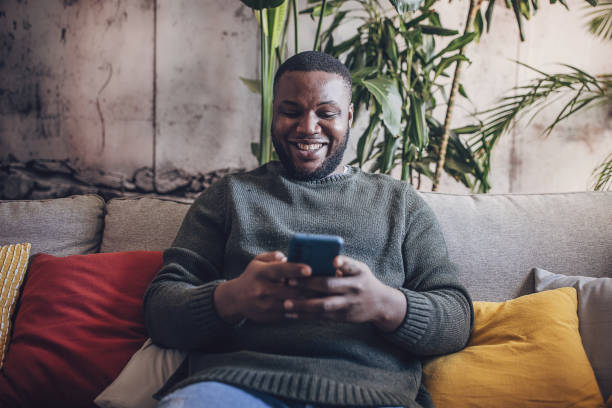 istock Engrossed in Smartphone at Home 1939862799