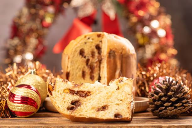istock Panettone, panettone with chocolate flavors on a rustic table with Christmas decorations. Selective focus. 1939870592