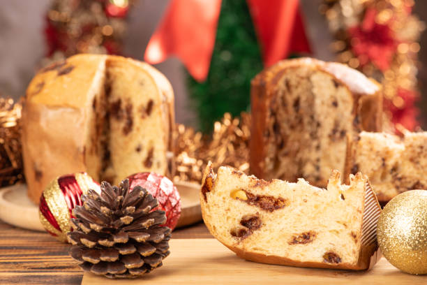 istock Panettone, panettone with chocolate flavors on a rustic table with Christmas decorations. Selective focus. 1939871660