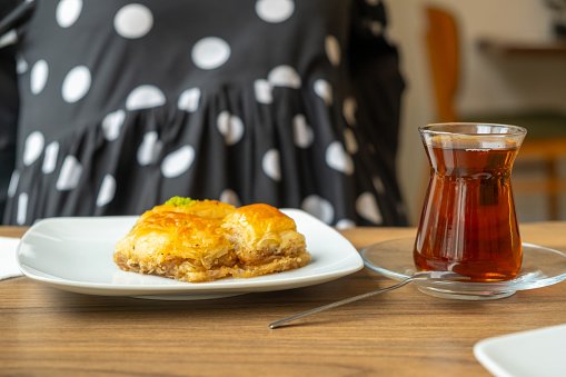 Baklava and tea on the table in Turkish cafe.