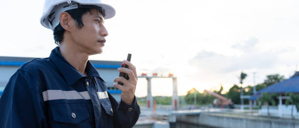 istock maintenance and inspector. Maintenance engineers are using walky talky to inform the results of inspection of buildings and structures. Irrigation engineers are exploring sluice systems 1939909138