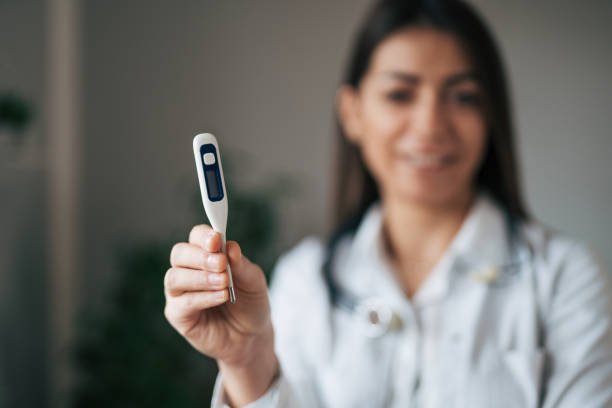 istock Female doctor holding digital thermometer 1939909162