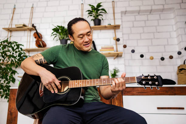 istock Chinese guitarist enjoys music 1939912587