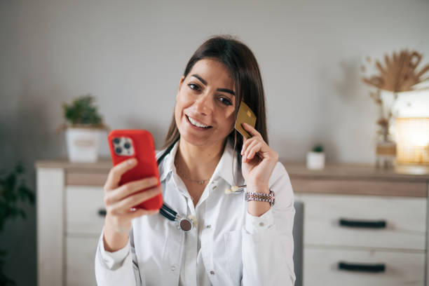 istock Adorable female doctor using smart phone 1939926955