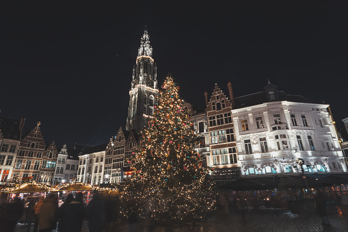 Christmas lights illuminate the cathedral in the historic centre of Antwerp. The beauty of the Christmas market in December in Belgium.