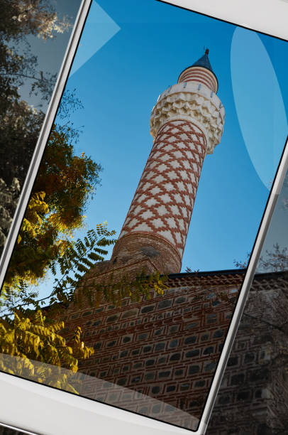 minaret of a mosque in plovdiv, bulgaria on smartphone - vibrant color new traditional culture saturated color imagens e fotografias de stock