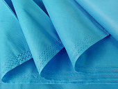 rolls of light blue non-woven fabric.