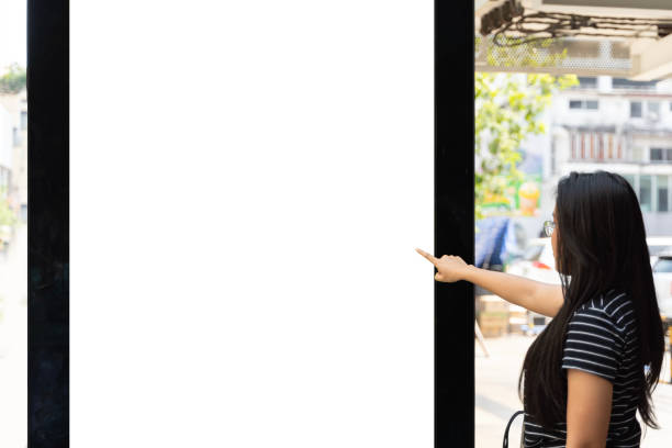 istock Young woman traveling using modern digital display with blank screen space for your message or content, beautiful woman watching bus movement. 1939989049