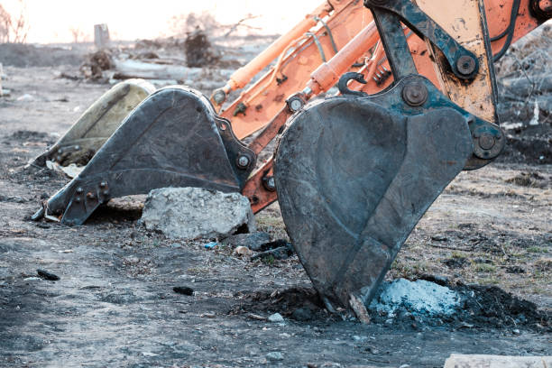 istock three buckets of the excavator rested on the ground 1940010236