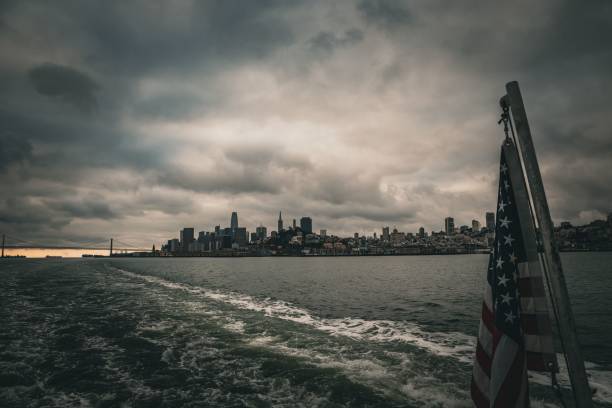 A city skyline view from a boat with the US flag