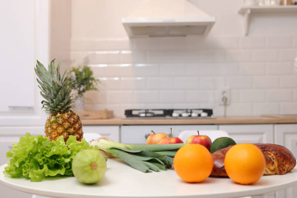 istock Beautiful kitchen interior design features white table adorned with group of fresh fruits and vegetables creating refreshing and healthy atmosphere with organic meals 1940061115