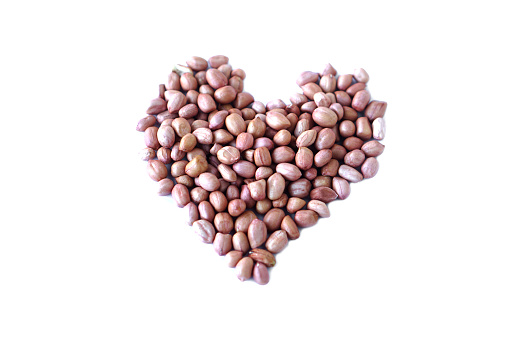 Peanut seeds, put in heart shape, isolated on white background. Concept, healthy food, grains with good for health, can be cooked as ingredient in various food menu or snack.