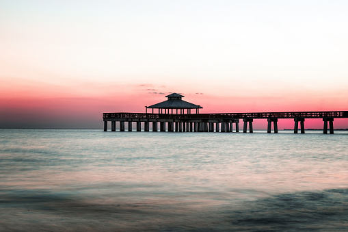 Sunset behind the pier of Fort Myers Beach, Florida USA