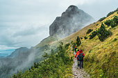 Group of backpacker hiking on trail in foggy mountain on the morning at Switzerland