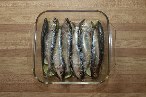 Close up view of sardines in glass container alone