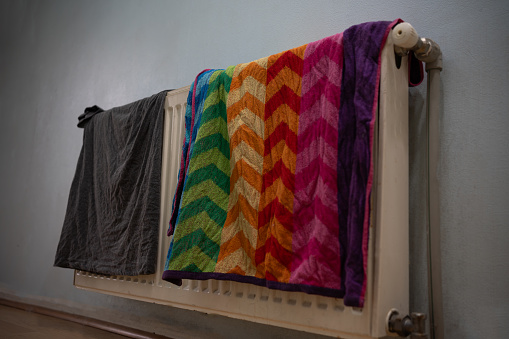 towel and t shirt drying on radiator, energy saving, residual heat