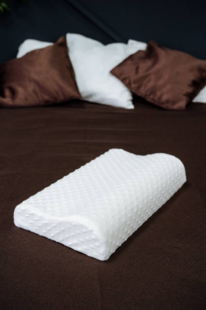 istock Orthopedic pillow for sleeping in white. Healthy spine in sleep. 1940092150