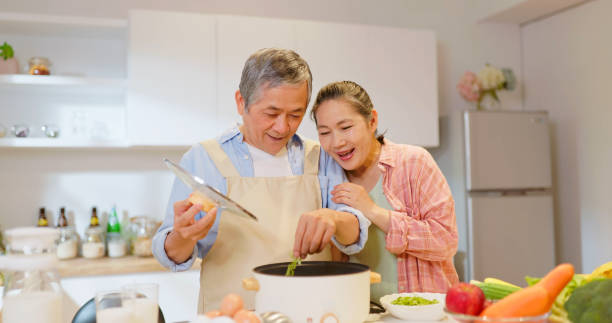 istock Asian elderly couple in kitchen 1940092375