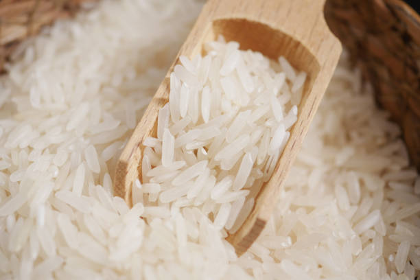 istock Raw white rice on a wooden spoon 1940092711