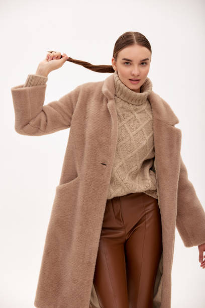 istock Model in a fur coat with artificial fur close-up, light background 1940092956
