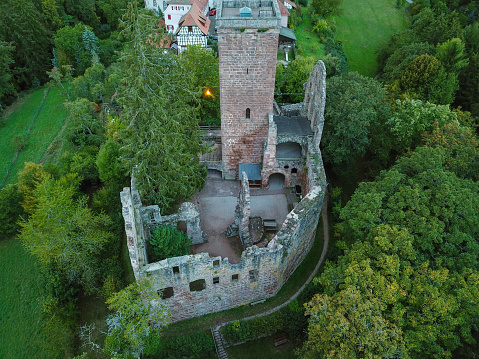 Neuffen, Germany - June 11, 2023: Burg Hohenneuffen - Hohenneuffen Castle on Top of green Swabian Alb Hill in Summer. Drone view towards the summer Swabian Alb Hill Range and Burg Hohenneuffen - Hohenneuffen Castle. Neuffen, Hohenneuffen Castle, Esslingen, Swabian Alb, Baden Württemberg, Southern Germany, Germany, Europe.