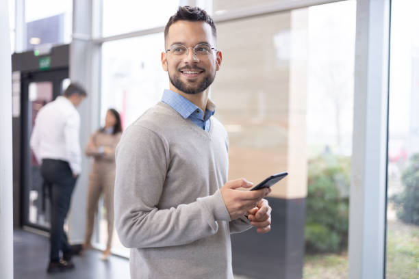 istock Man Holding Cell Phone, Essential Equipment for Office Professionals 1940103374