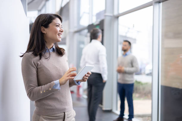 istock Woman Standing in Front of Wall With Tablet, Workplace Technology and Communication 1940103382
