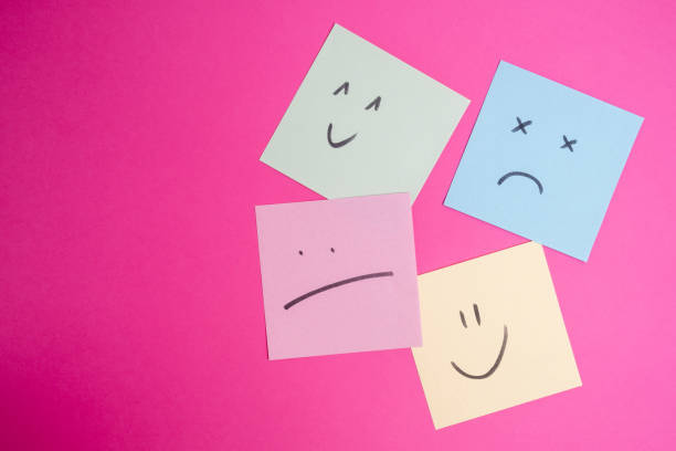 istock Paper cards with various emoticons on a colored background, banner and place for text. Conceptual image of positive thinking and satisfaction level 1940129542