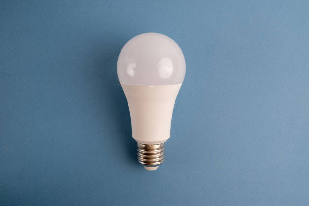 istock Paper and light bulb on a colored background. Idea and business concept. Place for text 1940130607
