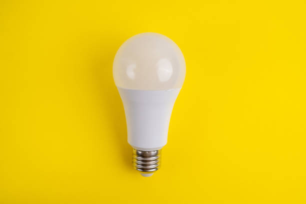 istock Paper and light bulb on a colored background. Idea and business concept. Place for text 1940130643