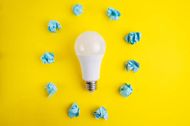 istock Paper and light bulb on a colored background. Idea and business concept. Place for text 1940131156