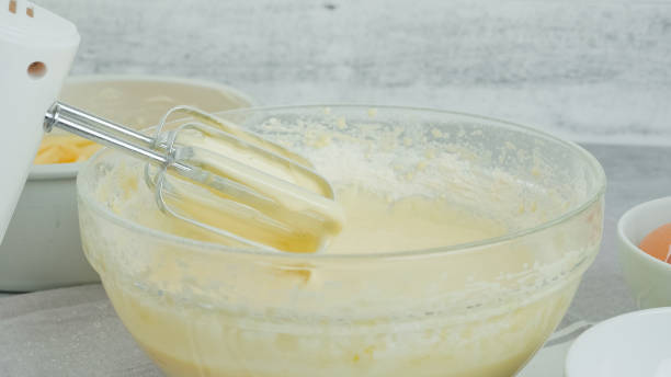 istock Cake batter in a glass bowl close-up on a kitchen table 1940139661