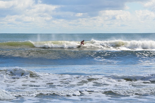 Surfer enjoying the day surfing at the ocean  beach Florida, USA.