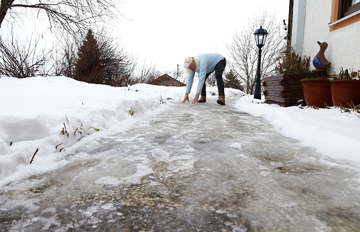 Risk of slipping on an icy sidewalk in winter