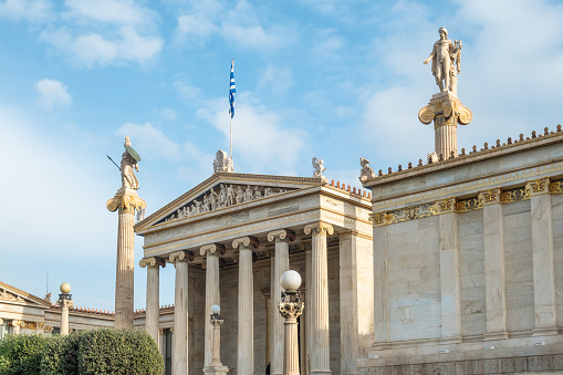 Academy of Athens with marble column with sculptures of Apollo and Athena in Athens, Greece. Popular landmark and travel destination.