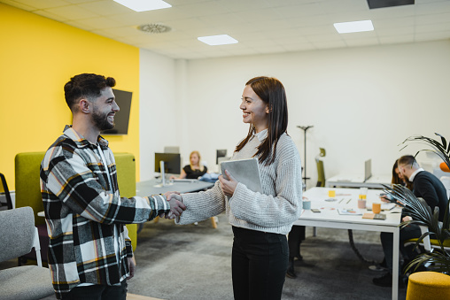 Male Intern Meeting Female Superior In Company And Shaking Hands