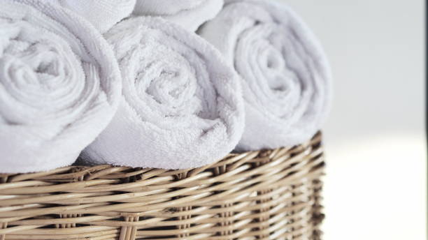 istock Towels on basket, with copy space blurred bathroom background. For product display montage.Spa set 1940231620