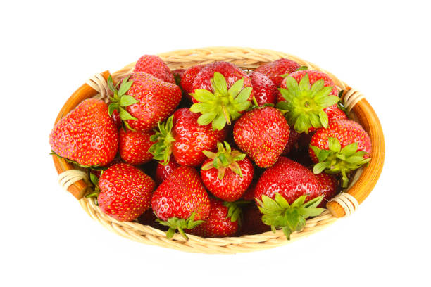 Fresh strawberry in basket on wooden background