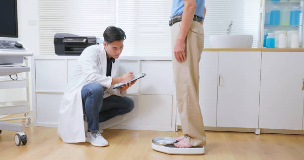 nutritionist measure senior man weight - dieting weight scale doctor patient stock-fotos und bilder