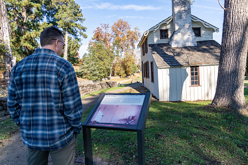 Fredericksburg, Virginia - November 4, 2023: Tourist man reads the sign and information about the Innis House - Battle of Fredericksburg - US Civil War - Sunken Road Trail