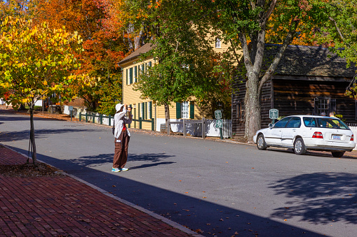 Old Salem, North Carolina, USA - October 26, 2023: Tourist taking pictures of this lovely historical town.